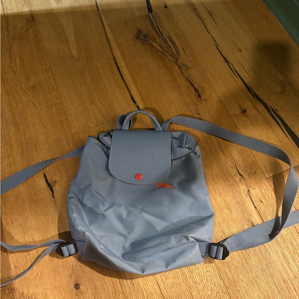 Blue Longchamp Backpack with Red Accents